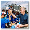 Governor Gray Davis giving a young boy a hi-five during a Fourth of July celebration.